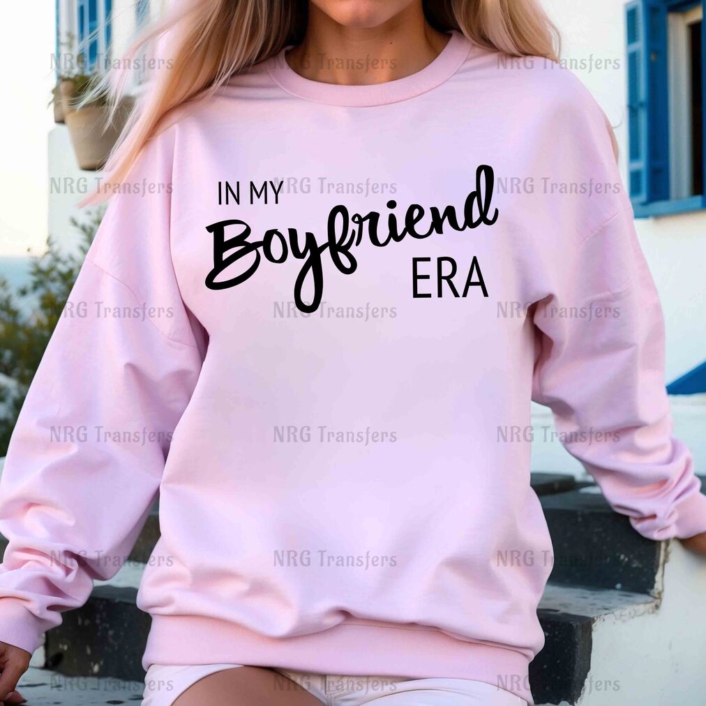 a woman wearing a pink sweatshirt that says in my boyfriend era