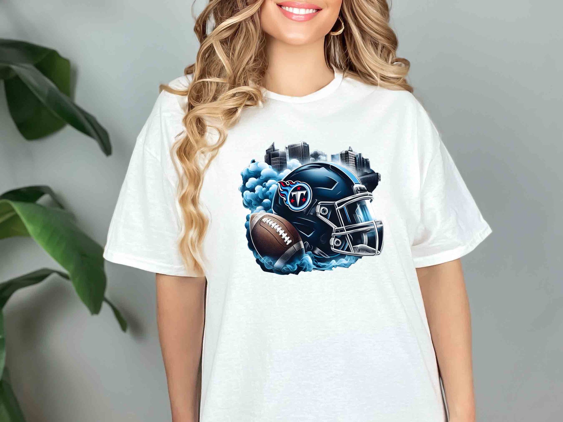 a woman wearing a t - shirt with a football helmet on it