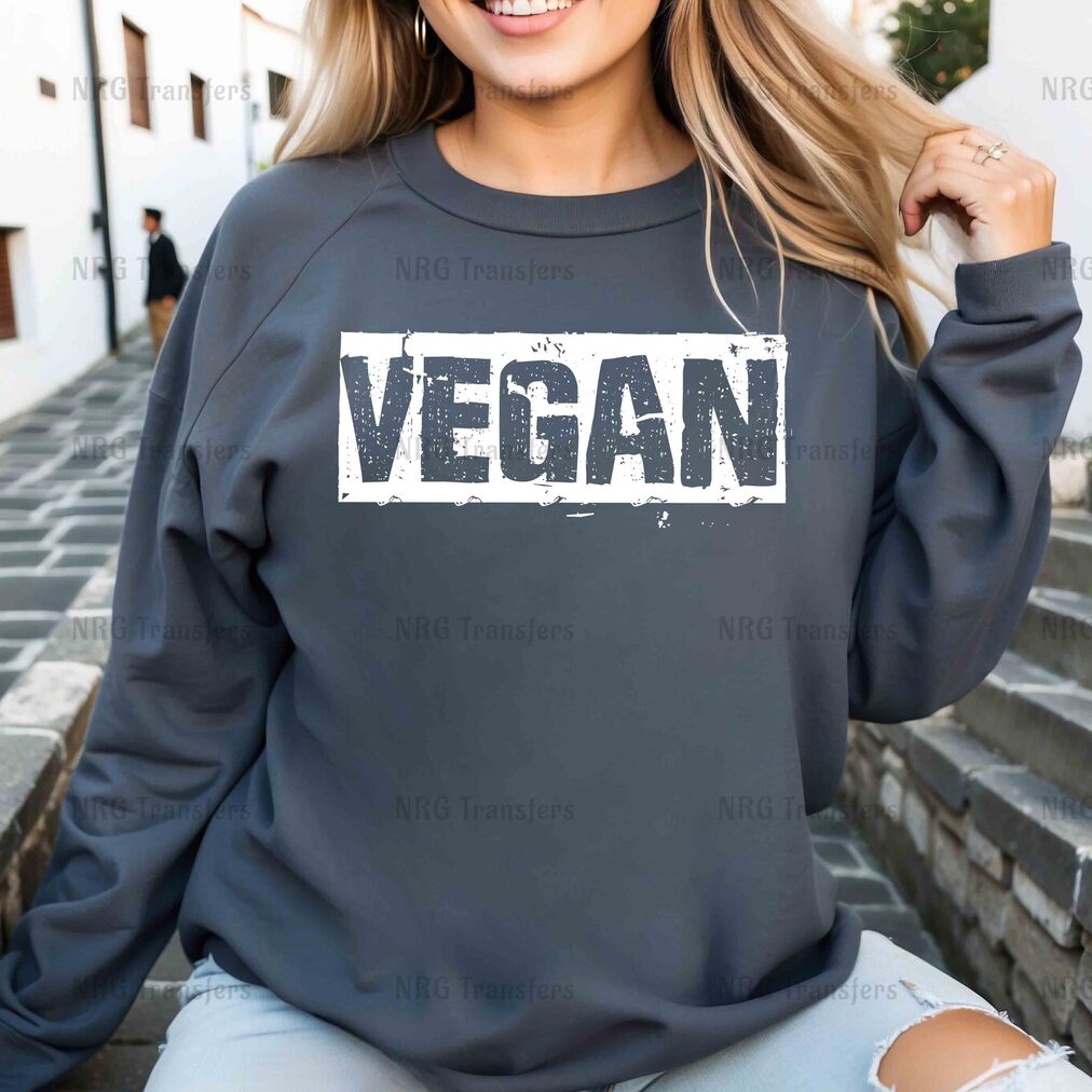 a woman wearing a sweatshirt with the word vegan printed on it