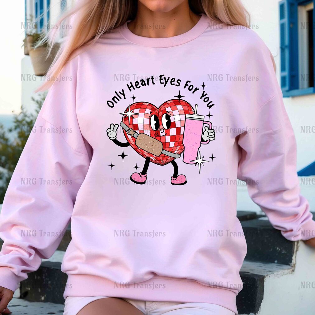 a woman wearing a pink sweatshirt with a heart on it