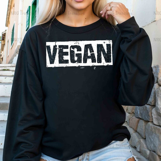 a woman wearing a black sweatshirt with the word vegan on it