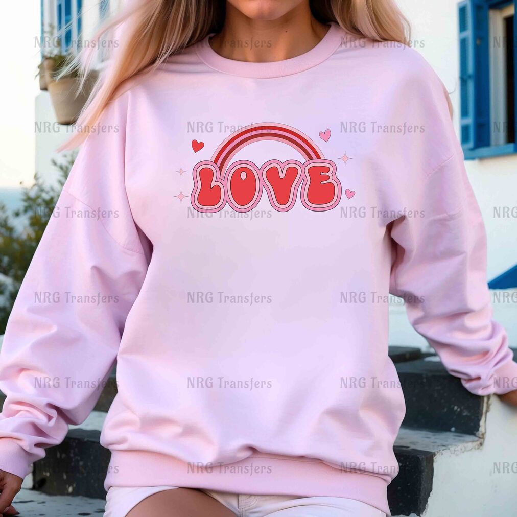 a woman wearing a pink sweatshirt with the word love on it