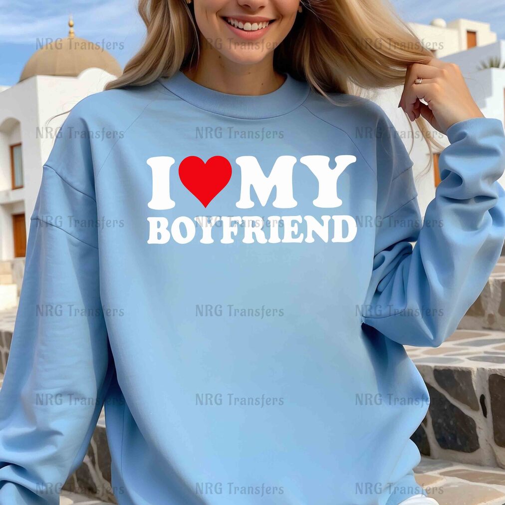 a woman wearing a blue sweatshirt that says i love my boyfriend