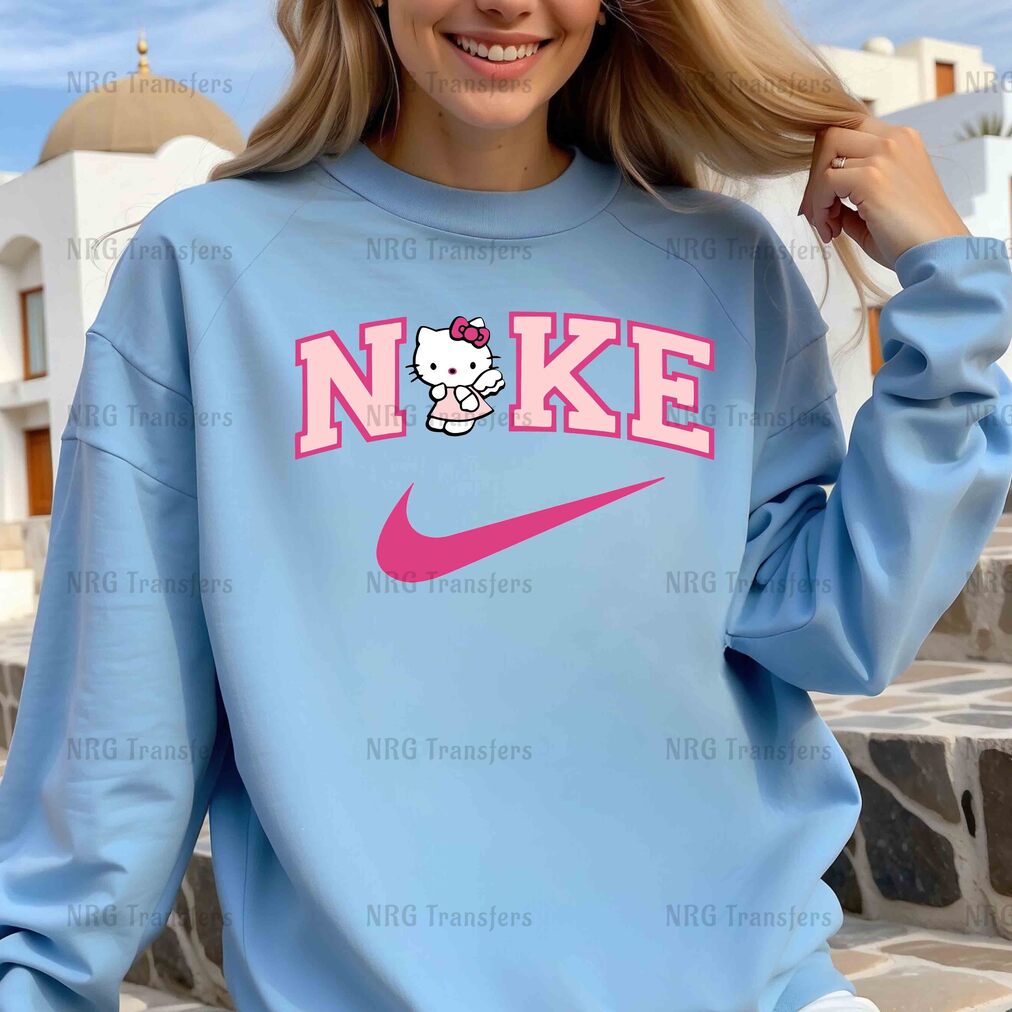 a woman wearing a blue sweatshirt with a hello kitty on it