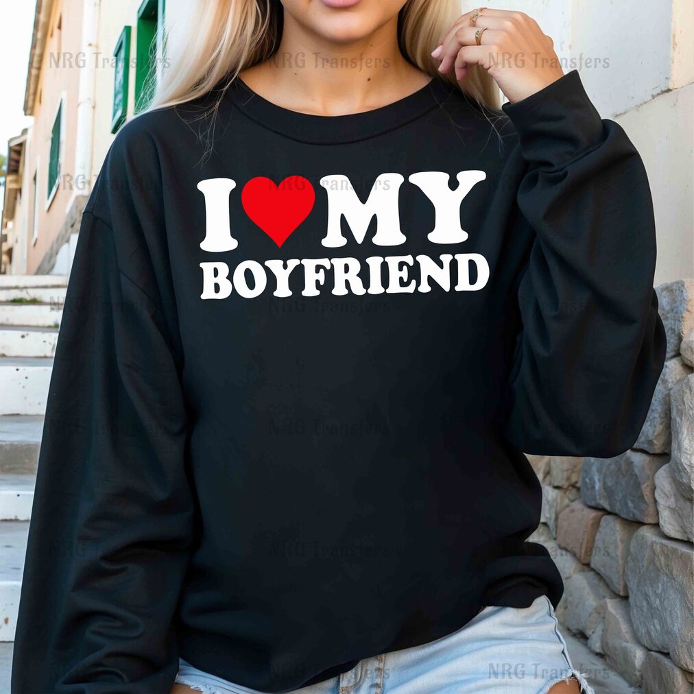 a woman wearing a black sweatshirt that says i love my boyfriend