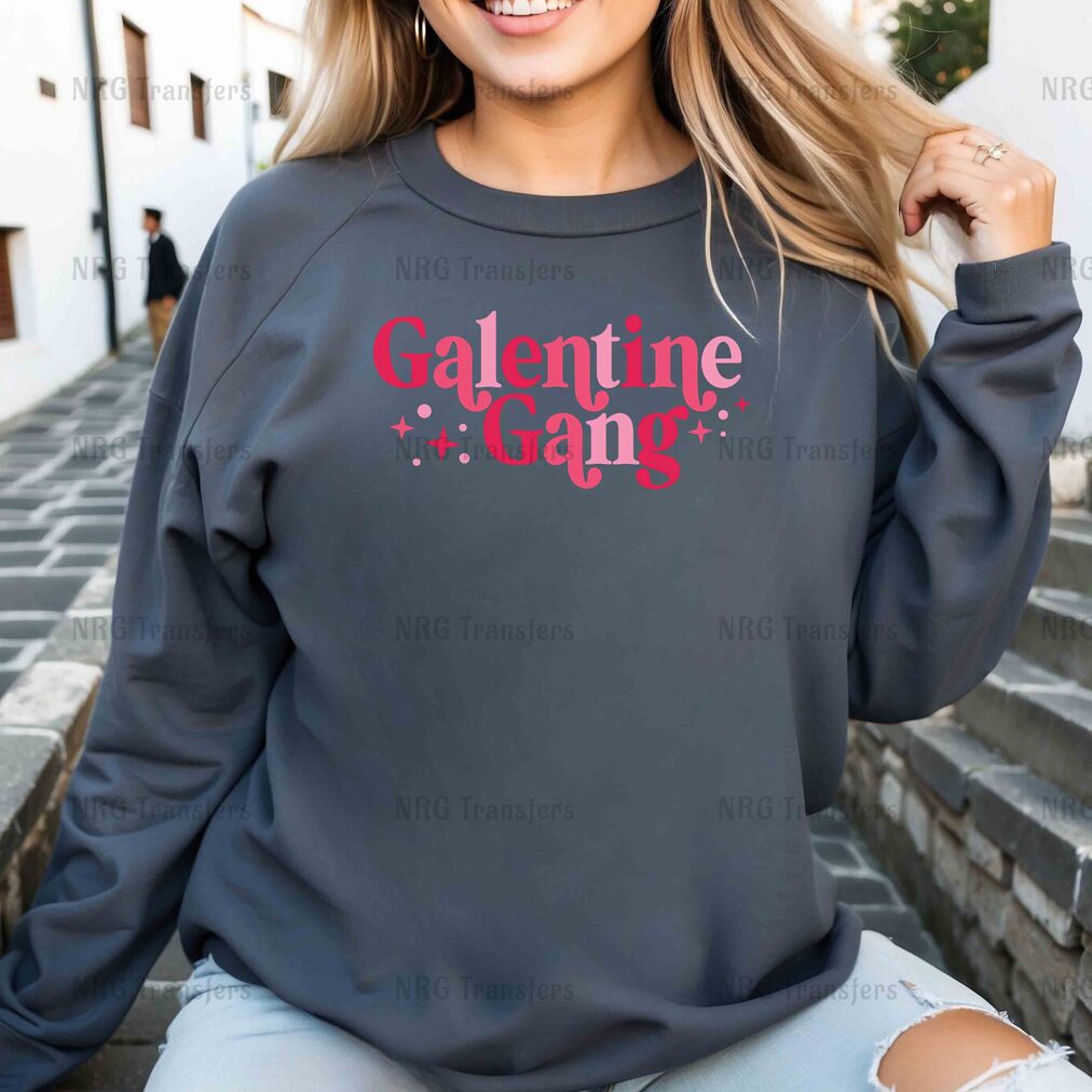 a woman wearing a grey sweatshirt with the words galette gang on it