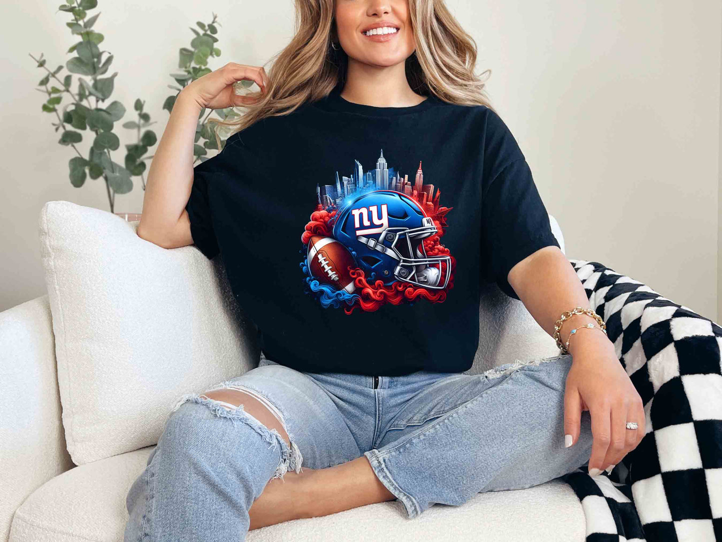 a woman sitting on a couch wearing a giants shirt