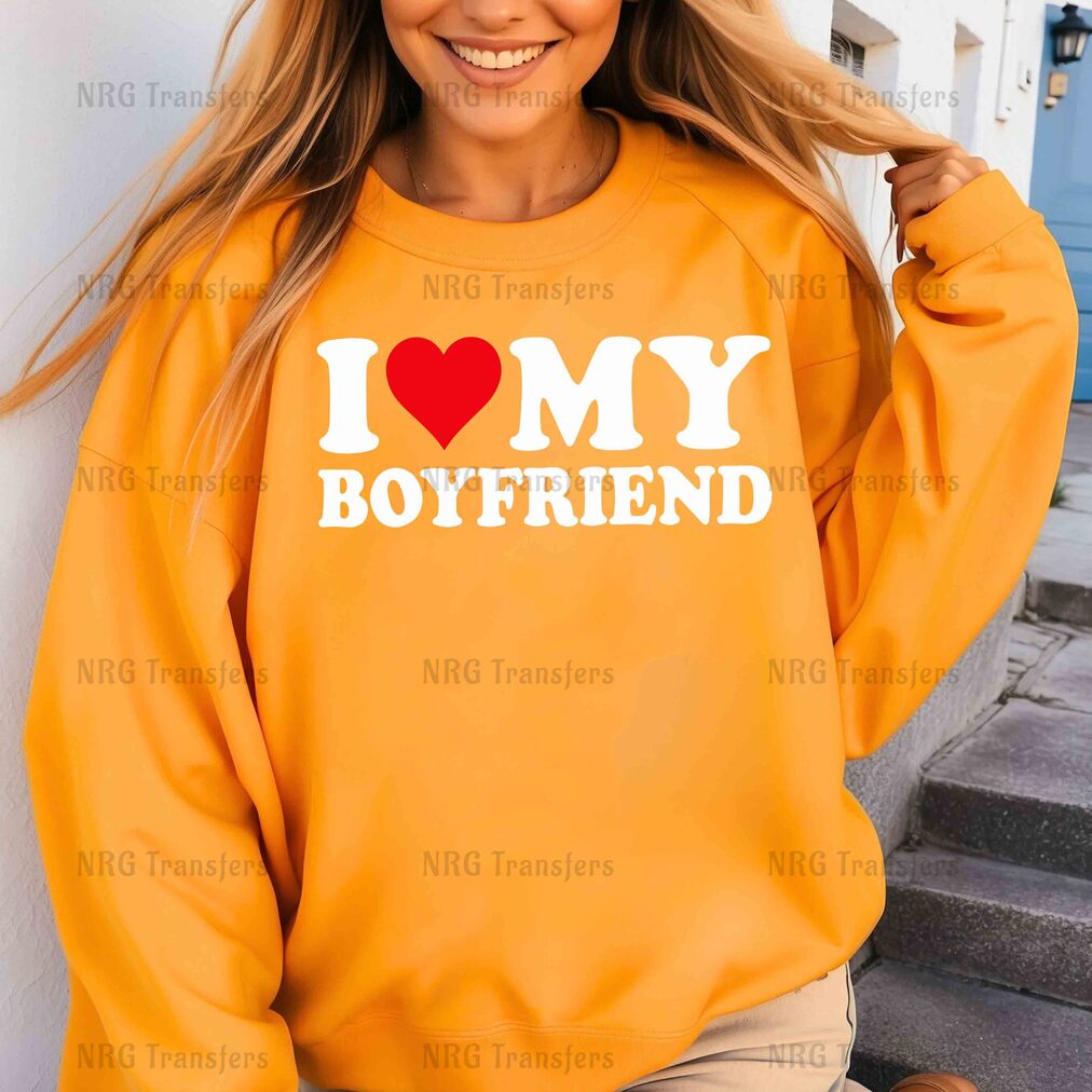 a woman wearing a sweatshirt that says i love my boyfriend