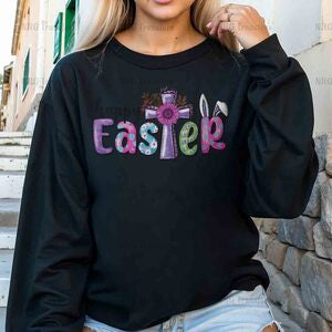 a woman wearing a black sweatshirt with the word easter printed on it