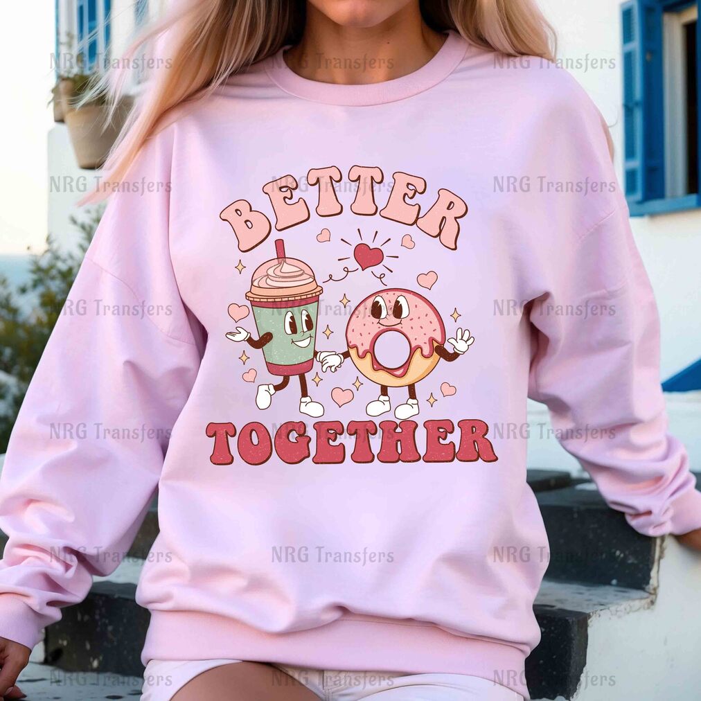 a woman wearing a pink sweatshirt with a donut and coffee on it