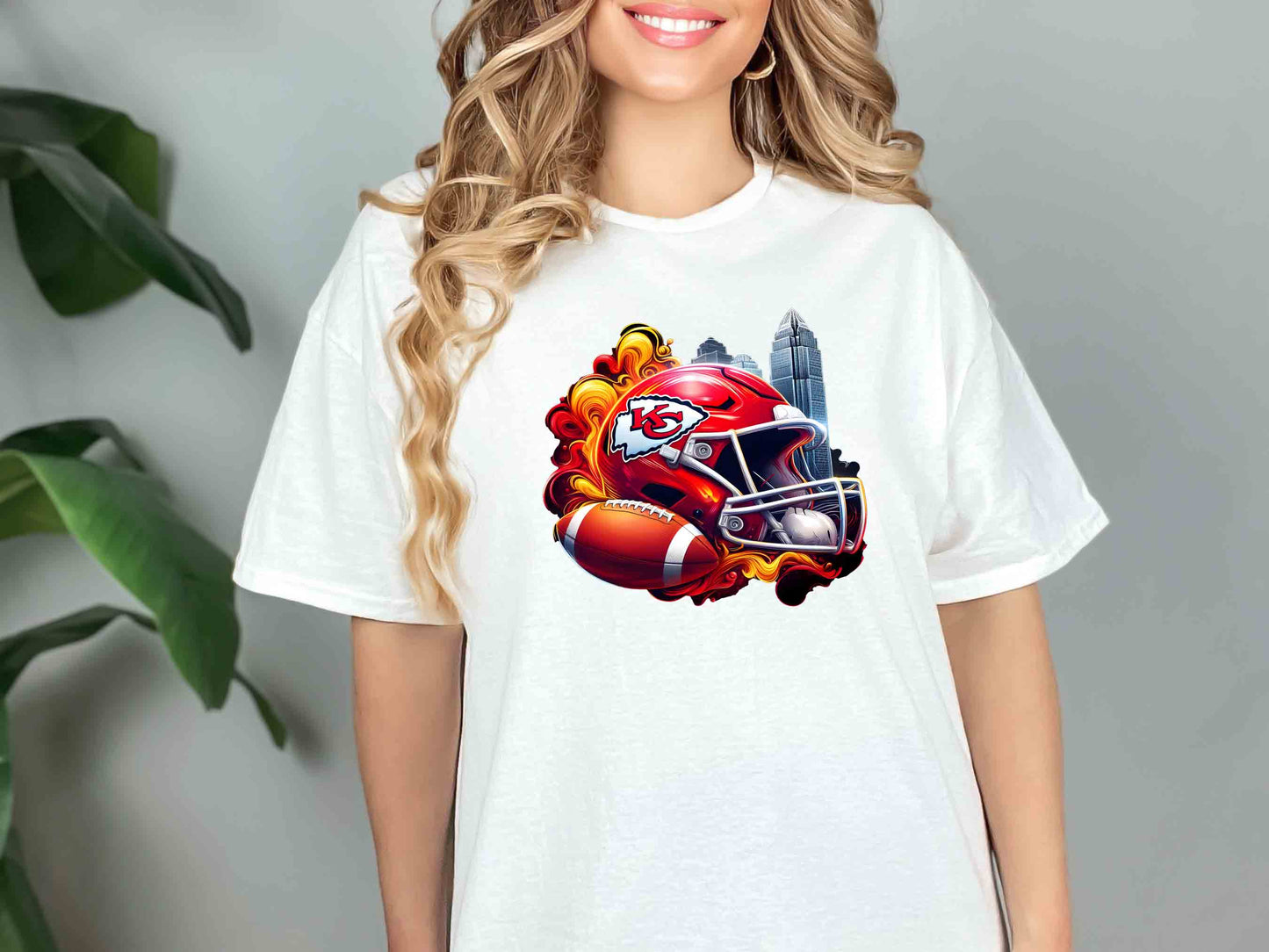 a woman wearing a t - shirt with a football helmet on it