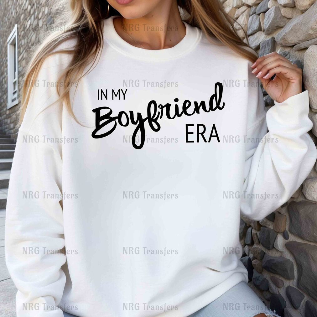 a woman wearing a sweatshirt that says in my boyfriend era