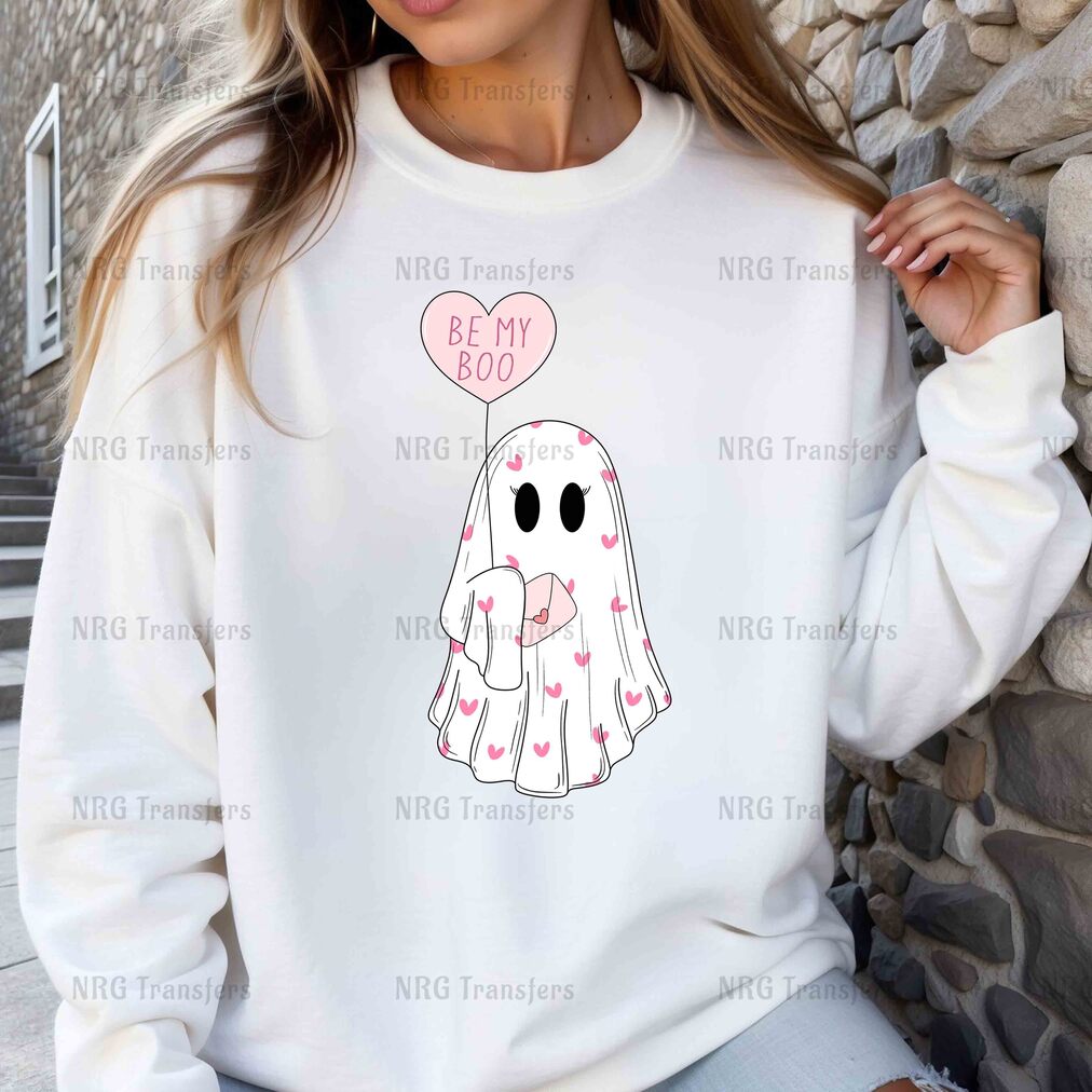 a woman wearing a white sweatshirt with a heart balloon on it