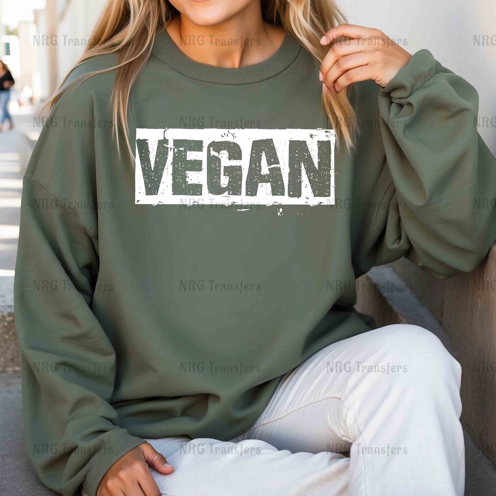 a woman wearing a sweatshirt that says vegan