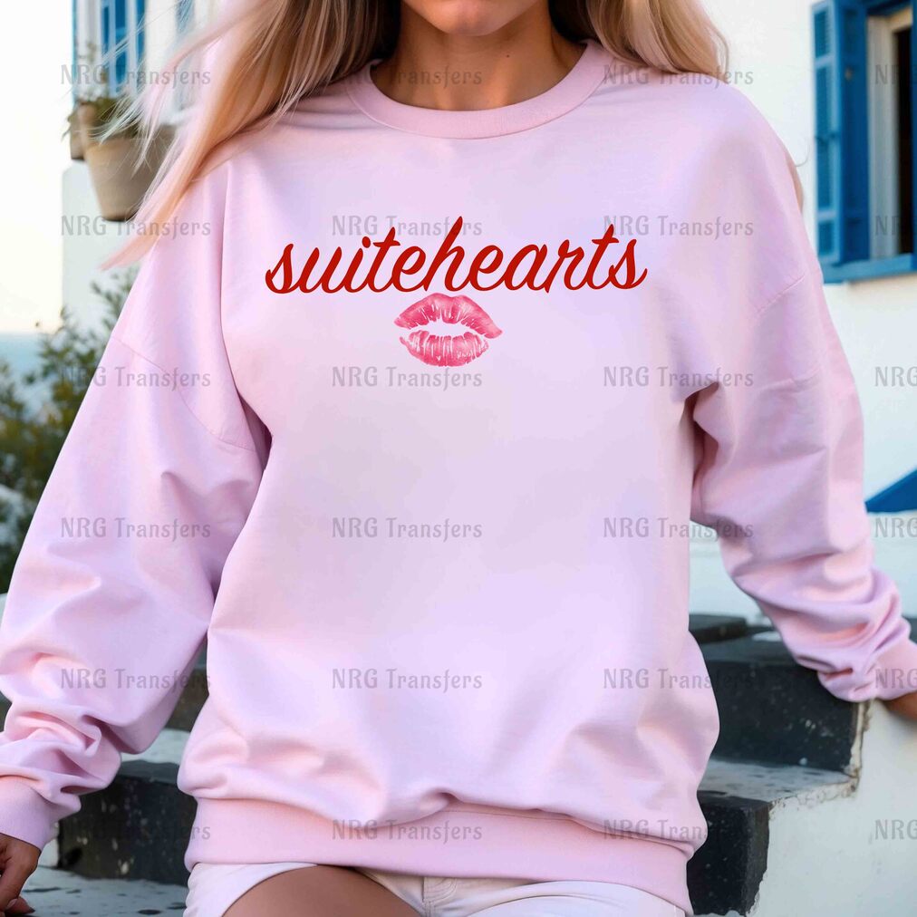 a woman wearing a pink sweatshirt with the words suiteheants on it