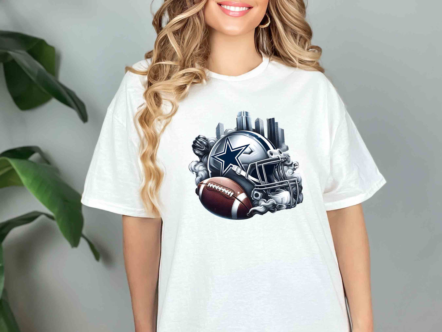 a woman wearing a white shirt with a football and helmet on it