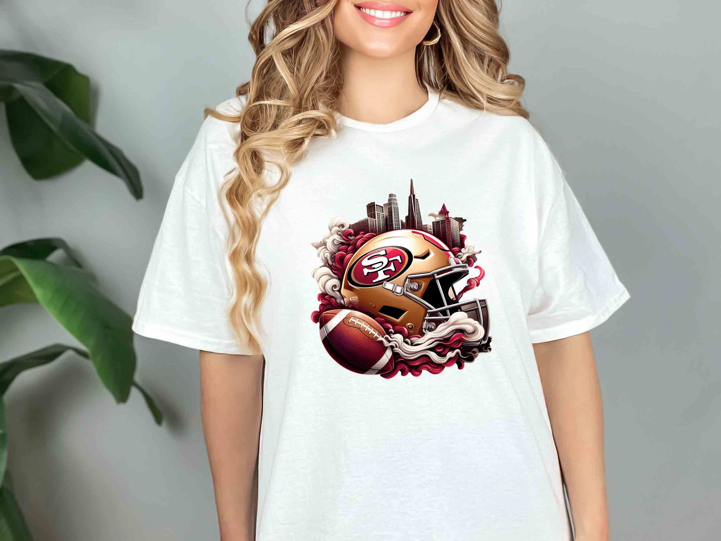 a woman wearing a white shirt with a picture of a football helmet on it