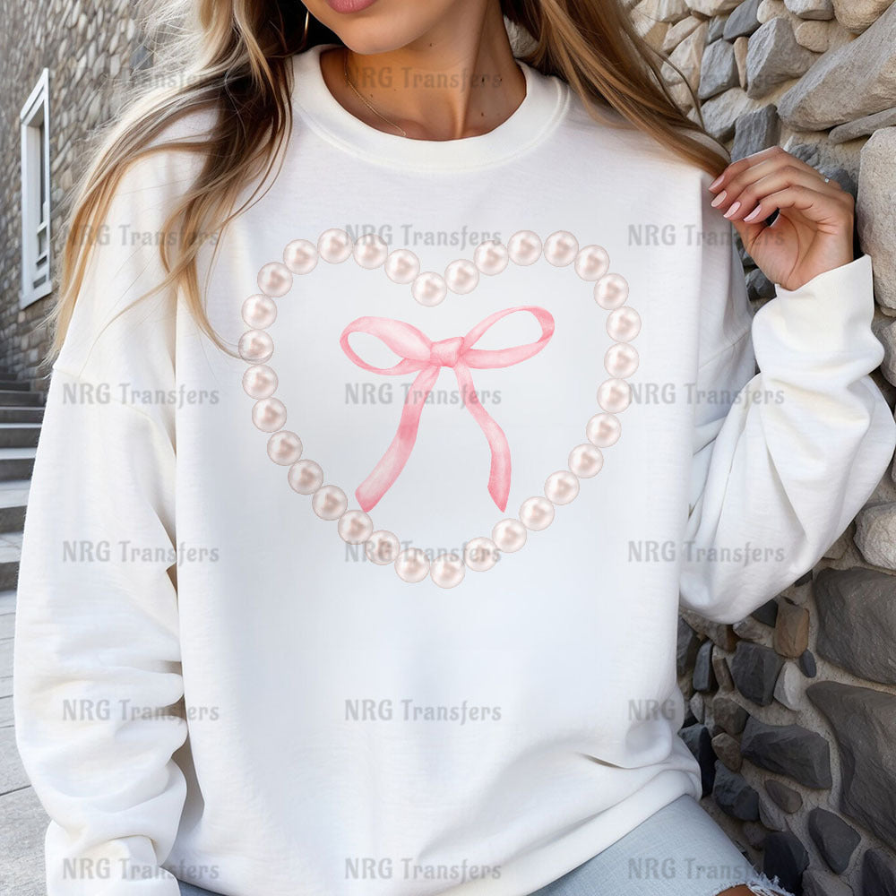 a woman wearing a white sweatshirt with a pink bow