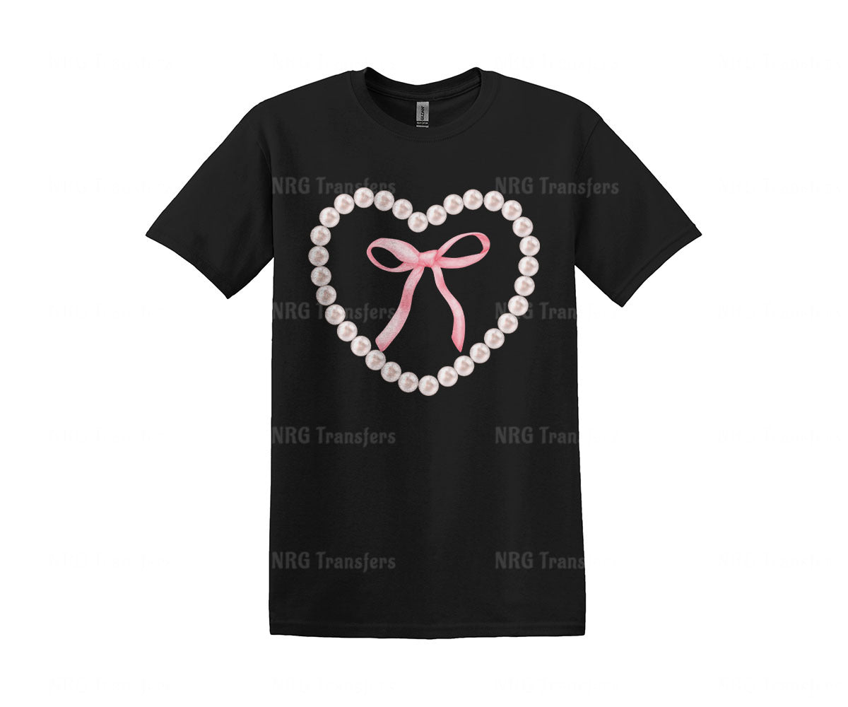 a black t - shirt with a pink bow and pearls in the shape of a