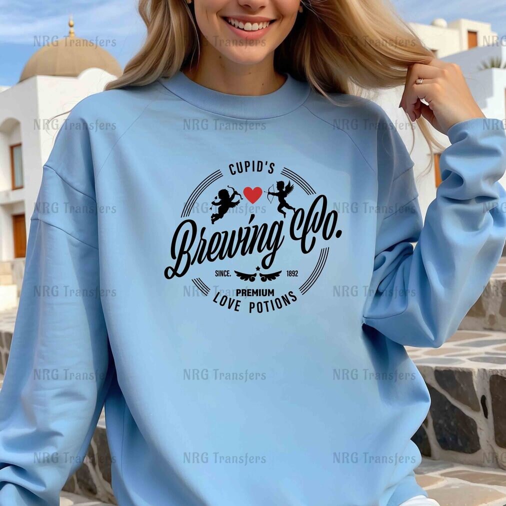 a woman wearing a blue sweatshirt with the words brewing co on it